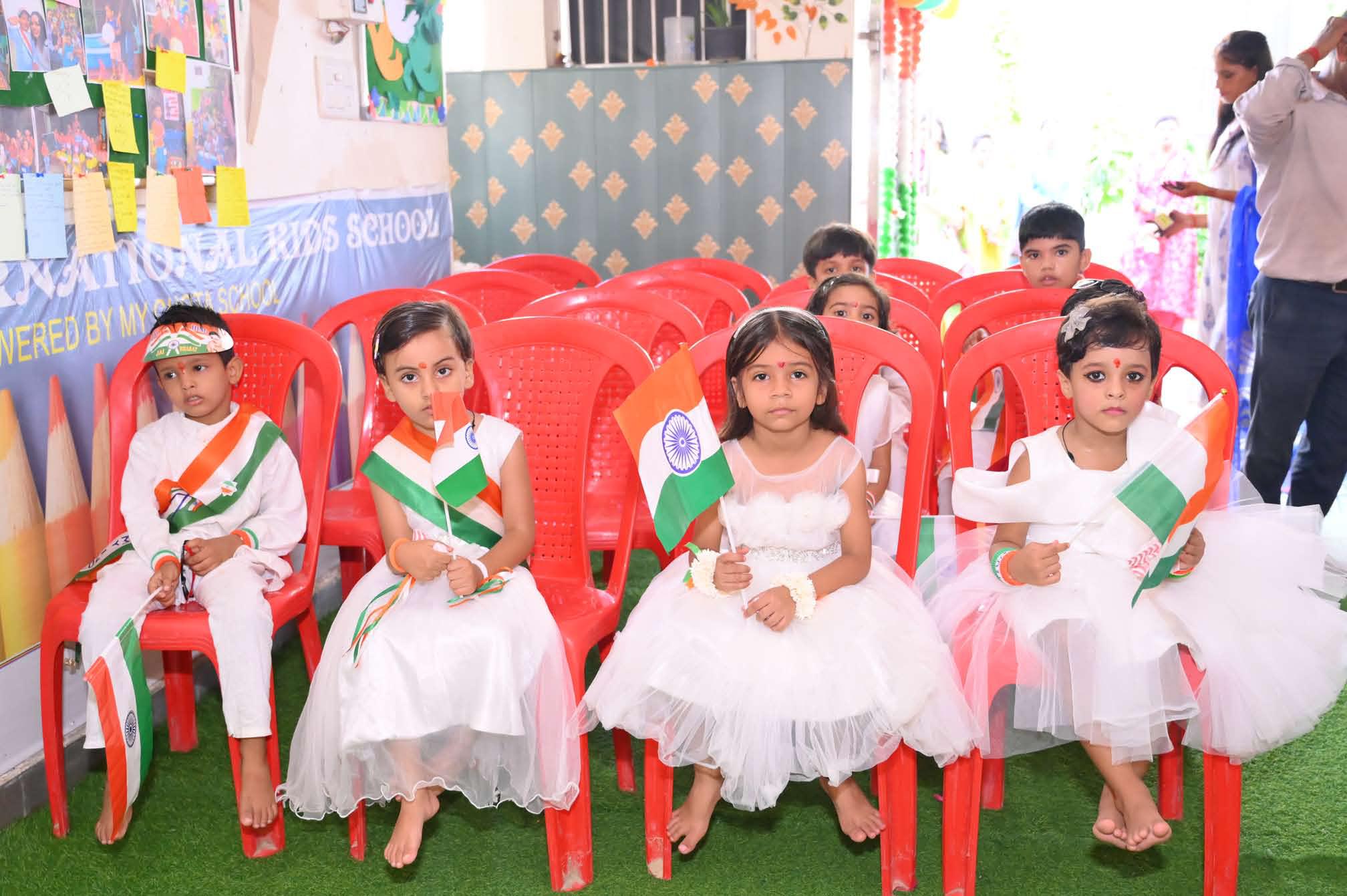 Children seated in costume, waiting to perform